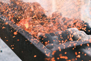 Dynamic image of a charcoal grill with vibrant sparks flying, capturing the essence of grilling heat.