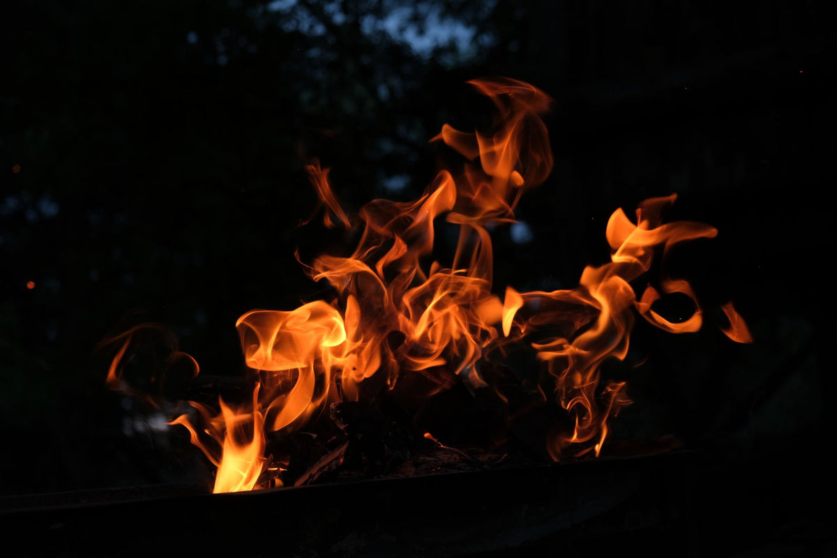 Captivating image of flickering flames in a dark night environment, showcasing fire's beauty.