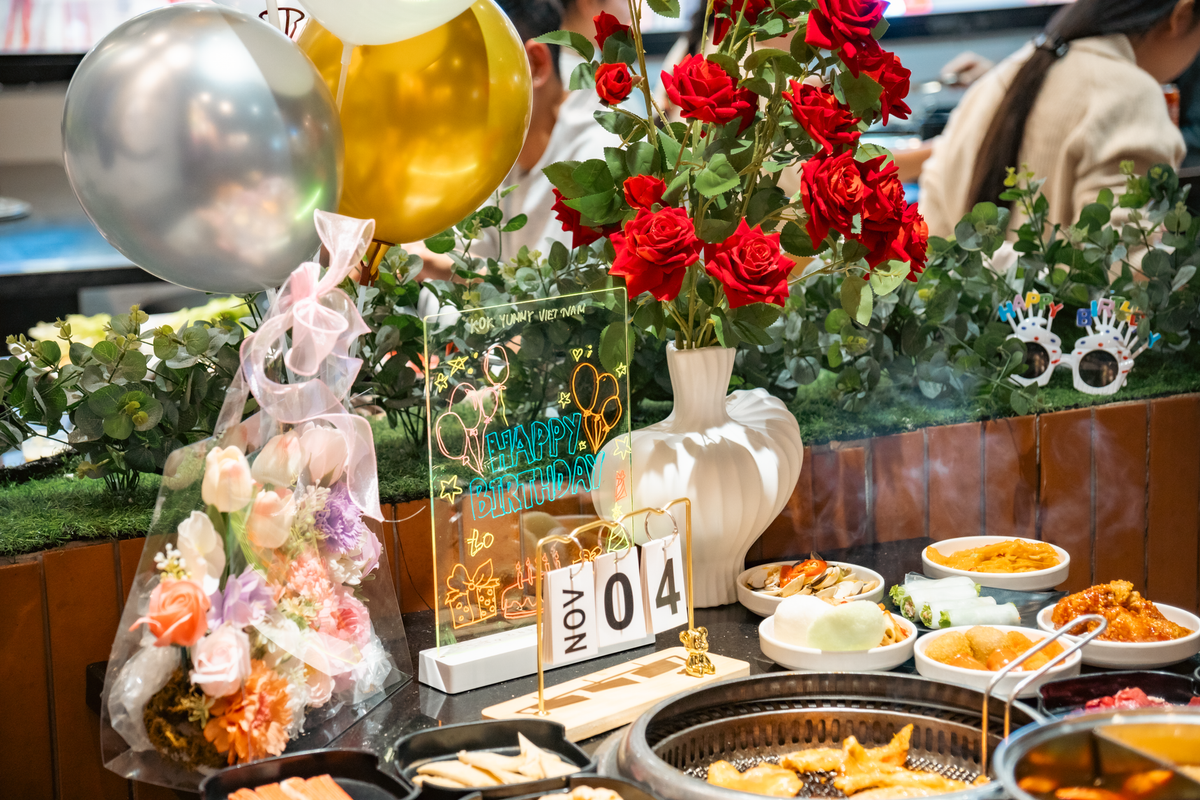 A vibrant birthday celebration featuring Vietnamese cuisine and festive decor.
