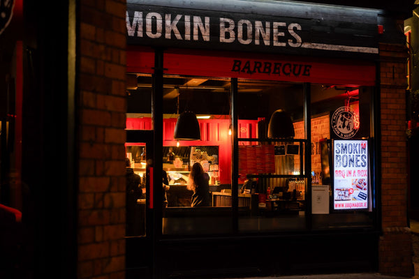 Warm ambiance of Smokin Bones Barbecue restaurant in Dublin at night, showcasing urban nightlife.