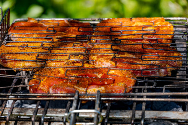 Succulent barbecue pork chops sizzling on a grill, capturing the essence of outdoor cooking.