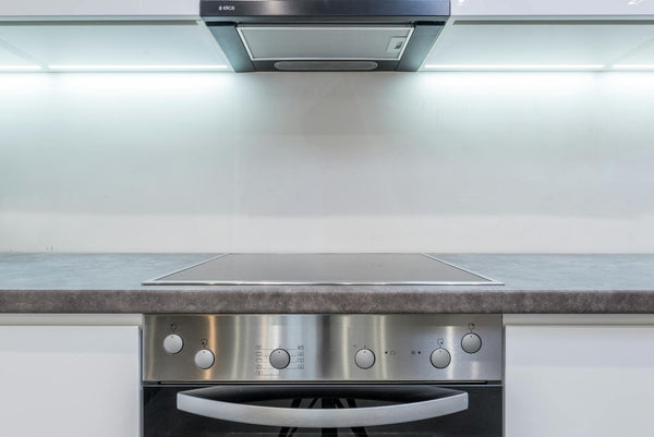 A sleek, modern kitchen with steel appliances and minimalist design.