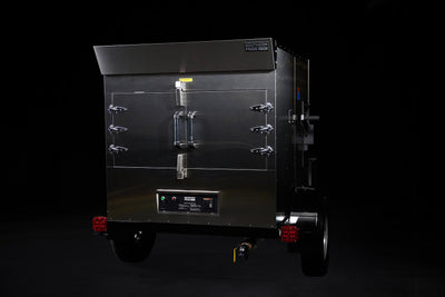 Southern Pride SPK-500 Mobile trailer-mounted gas rotisserie smoker, rear three-quarter view on the trailer