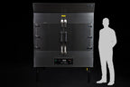 Southern Pride SP-700 commercial gas rotisserie smoker shown to scale beside a person