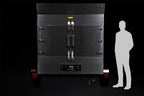Southern Pride SP-700 Mobile trailer-mounted gas rotisserie smoker shown to scale beside a person