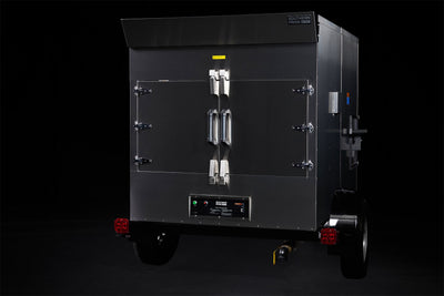 Southern Pride SP-700 Mobile trailer-mounted gas rotisserie smoker, left side view on the trailer