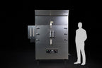 Southern Pride SPK-1400 commercial gas rotisserie smoker, shown to scale beside a person