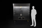 Southern Pride SPK-500 commercial gas rotisserie smoker shown to scale beside a person