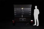 Southern Pride SPK-500 Mobile trailer-mounted gas rotisserie smoker shown to scale beside a person